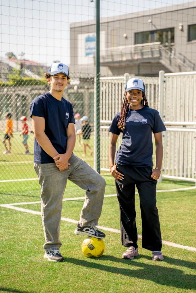 Young people wearing T-shirts and caps from Decathlon's charity line and Sport dans la Ville