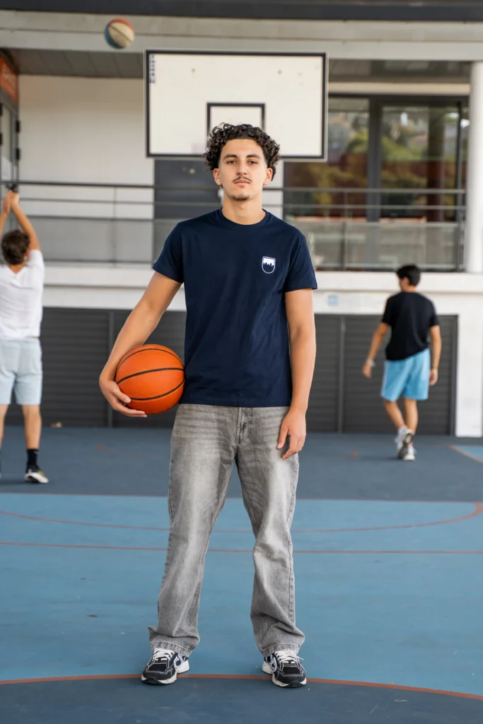 Young man wearing a Decathlon charity-themed T-shirt and Sport dans la Ville